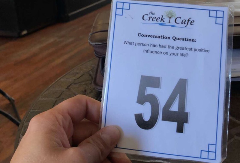 Photo of laminated conversation starter card at restaraunt with number 54 prominent
