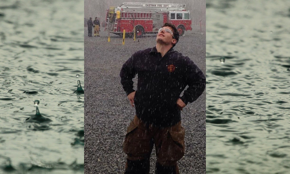 Tony Price the fireman gazes up into the rain