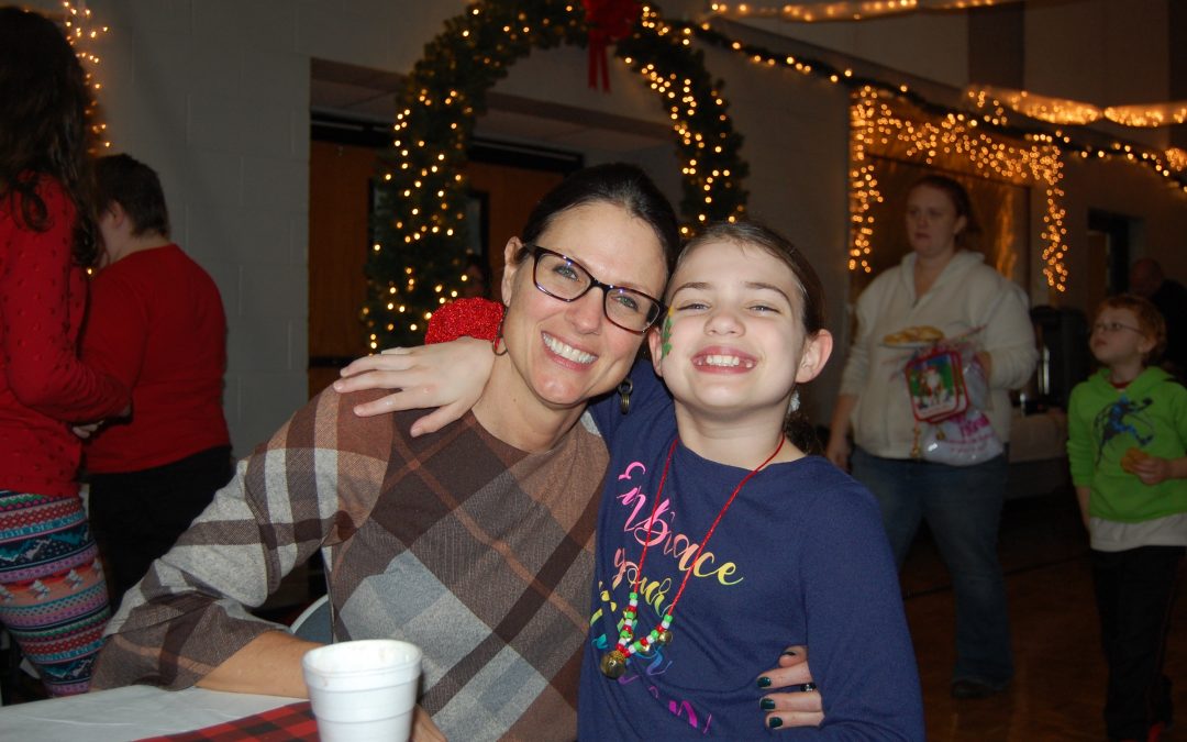 laine and her daughter Marley smiling just days after the fire at a community Christmas event