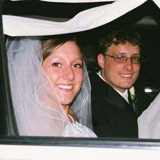 Zac and Priscilla on their wedding day. sitting in the back of the car all dressed up.